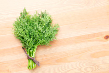 Fresh dill on a light wooden background