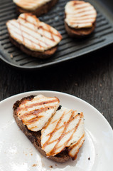 Crostini with fried cheese on the grill