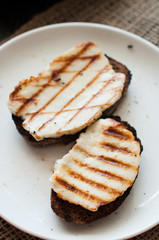 Crostini with fried cheese on the grill