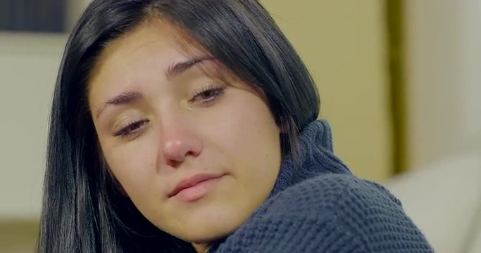 Young woman singing and crying at home closeup