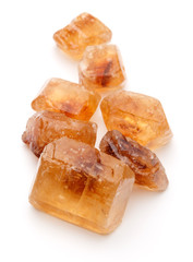 Brown caramelized lump cane sugar cube isolated on white backgro