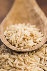 Spoon of brown rice close up