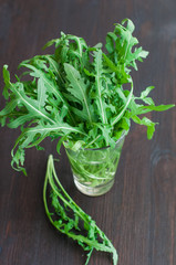 fresh ruccola leaves on the wooden background