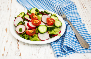 Spring salad with tomato, cucumbers and radish