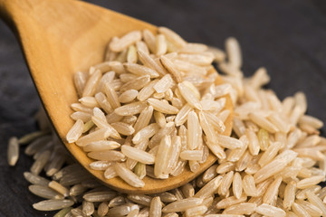 Spoon of brown rice close up