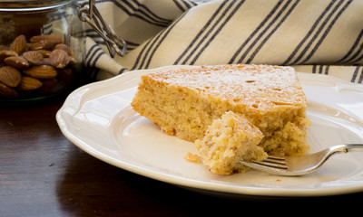 Lemon Almond Cake Slice with Fork on White Plate