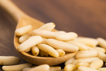 Dry Organic Pine Nuts on Wooden Background