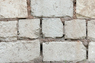 Wall of white brick and cement.