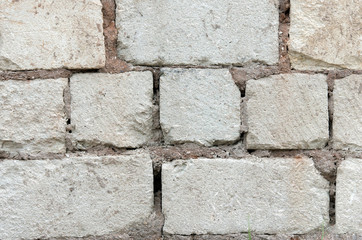 Wall of white brick and cement.
