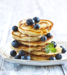 Stack of pancakes with fresh blueberry and honey