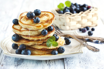 Stack of pancakes with fresh blueberry and honey