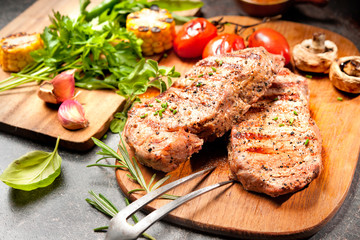 Grilled veal steaks on cutting board