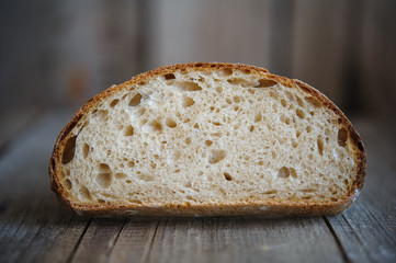 Freshly baked homemade bread on rustic wood background