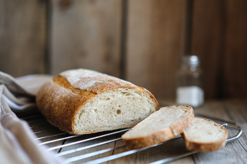 Freshly baked homemade bread on rustic  wood background