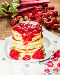 Pancake stack on plate with strawberries