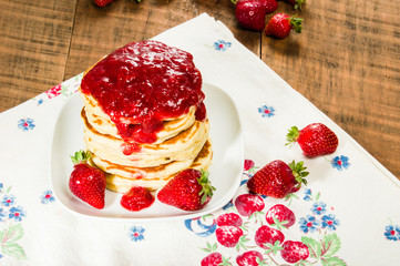 Pancake stack on plate with strawberries