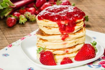 Pancake stack on plate with strawberries