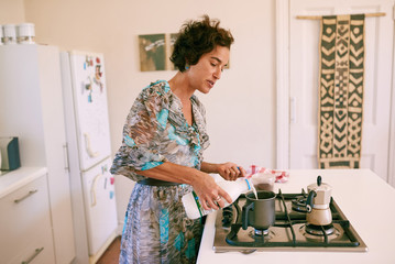 Mature woman making coffee in the morning