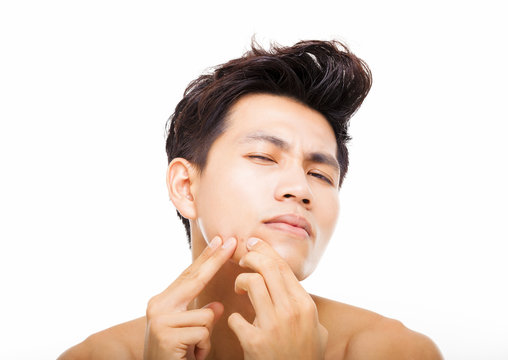 handsome young man Squeezing pimple