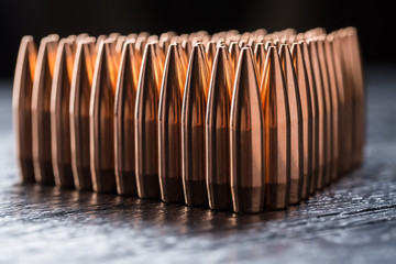 Macro shot of copper bullets that are in many rows to form a tri