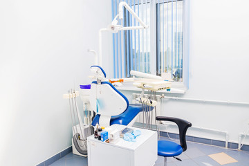 Dentist tools and chair in a dentist office