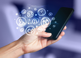 Hand holding smartphone with mobile app choices