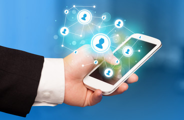 Finger pointing on smartphone, social network concept