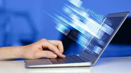 Close up of man typing on laptop computer