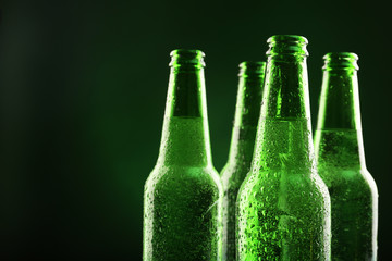 Glass bottles of beer on dark background