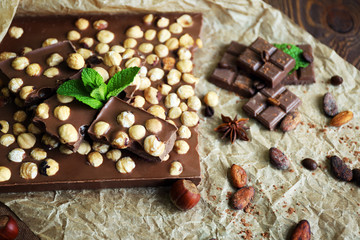 Obraz na płótnie Canvas Delicious chocolates with spices on table, closeup
