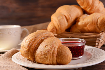 Delicious croissants on plate on table close-up