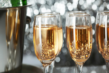 Glasses of champagne on bright background