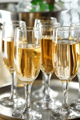 Glasses of champagne on bright background