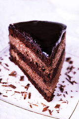 Piece of chocolate cake on white plate, closeup