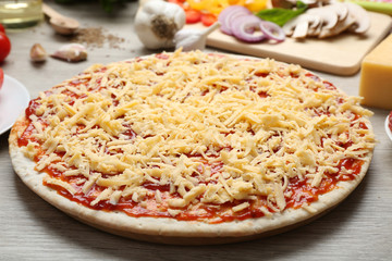 Raw pizza on table close up