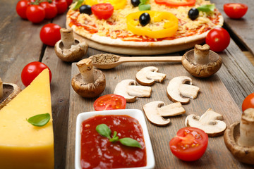 Food ingredients for pizza on table close up