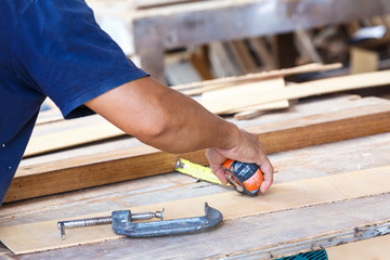 carpenter use saw cut wood for make new furniture