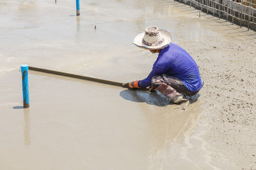 plasterer concrete worker at floor of house construction