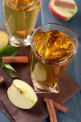 Glasses of apple juice on wooden table, closeup