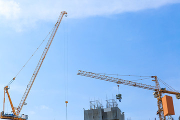Building crane and construction site under blue sky