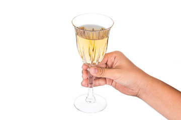 Hand holding white wine in crystal glass and ready to toast