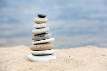 Fototapeta na wymiar Zen stones balance spa on beach