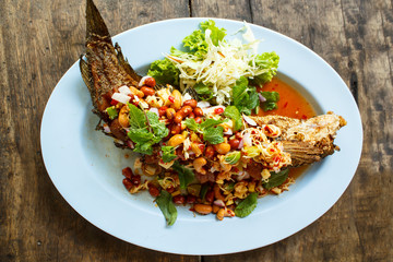 Deep fried fish with herb and spicy sauce.