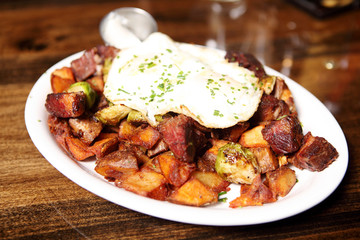 Corned beef hash with brussel sprouts and eggs over easy.