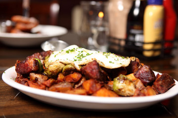 Corned beef hash with brussel sprouts and eggs over easy.