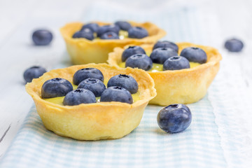Tartlets with lemon curd and blueberries, closeup