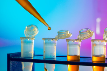 PCR strip test tubes and micropipette in genetics laboratory