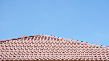dark brown roof against blue sky