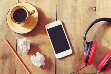 top view image of smartphone with blank screen headphones