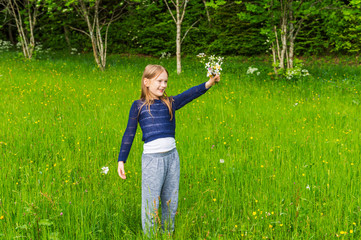 Cute little girl picking wildflowers